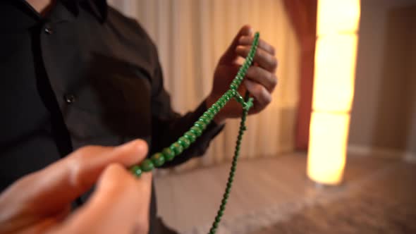 Muslim man praying and rosary.