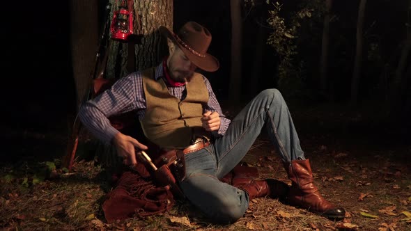 Cowboy with a Handgun in the Forest at Night