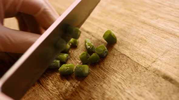 Woman's Hands Cutting Piattoni Frozen Green Beans Close Up