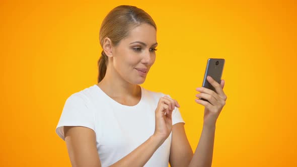 Pretty Woman Pointing at Smartphone, Easy Banking Application, Satisfied Client