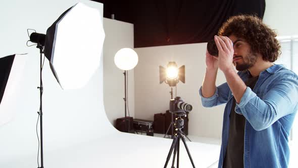 Photographer checking camera lens