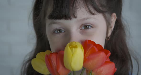 Cute little girl with flowers. 