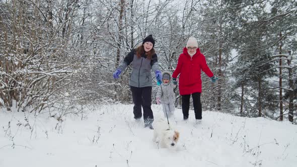 Happy Family Play with Dog Jack Russell Terrier In Snowy Day In Forest