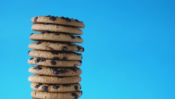 A Stack Chocolate Chip Cookies Rotate on a Blue Background