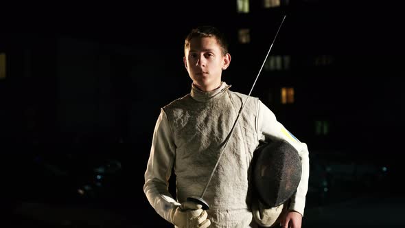 Portrait Of Young Fencer Man Looking Into Camera On The Street.