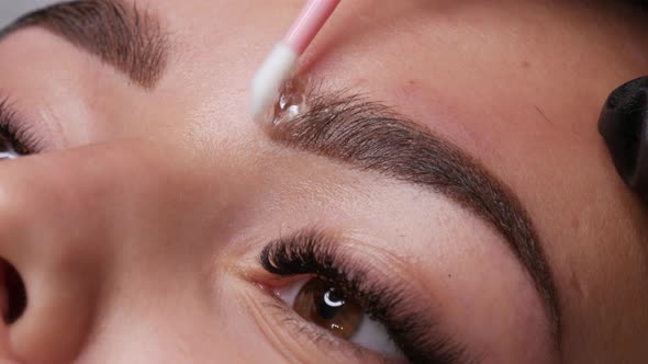 Applying a Special Fixing Gel with a Cotton Swab