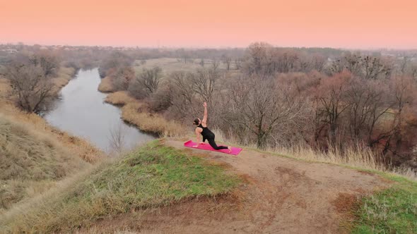 Young Woman Doing Yoga in Quiet Scenery