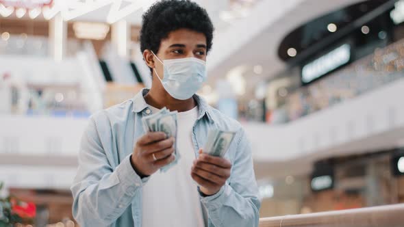 African Guy in Protective Face Mask Sick Masked Man Counts Money Dollars Banknotes Cash Financial