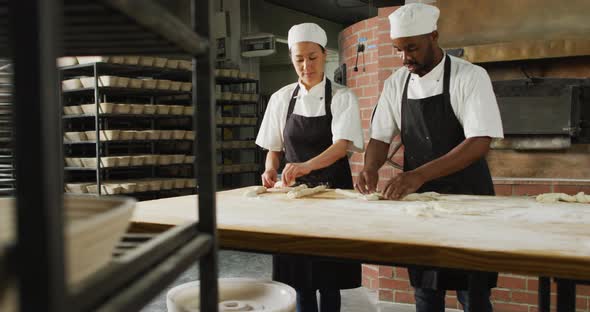 Animation of diverse female and male bakers preparing roll at bakery