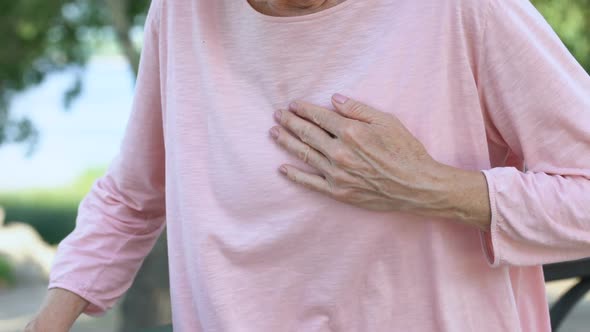 Adult Woman Having Breathing Problem, Feels Heart Attack During Walk in Park