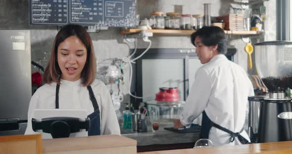 woman and man barista owners cafe working win success order today at the counter of coffee shop