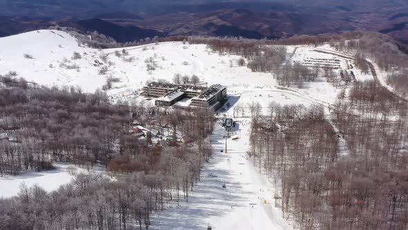 Aerial view at the ski slopes on a sunny winter day