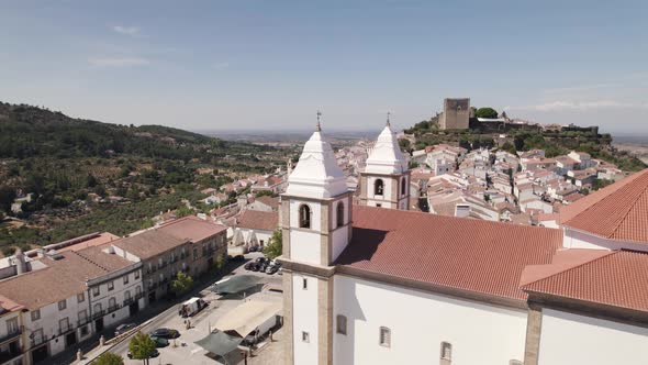 Church of Santa Maria da Devesa and castle ruins in background, Castelo de Vide in Portugal. Aerial