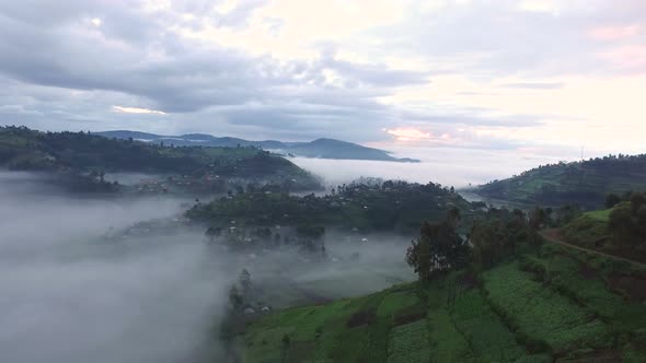 Aerial view of villages on hills covered by clouds