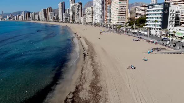 Aerial footage of Benidorm Playa Levante beach, hotels, buildings and restaurants