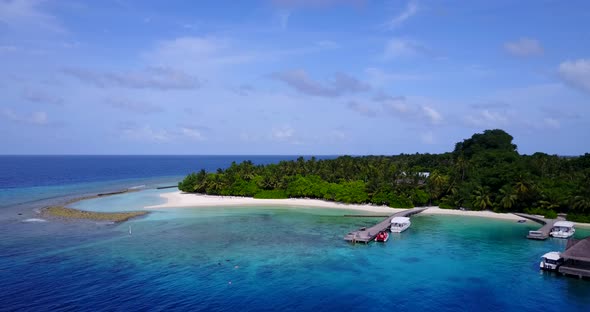 Luxury aerial clean view of a white paradise beach and aqua blue water background in vibrant 4K