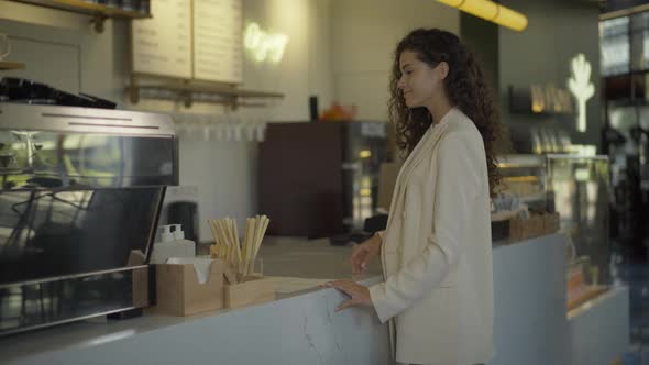 Confident Beautiful Businesswoman Taking Order in Cafe and Leaving with Two Coffee Cups. Portrait of