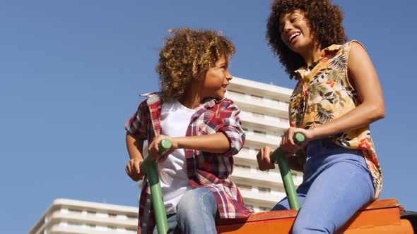 Mother and son having fun at playground