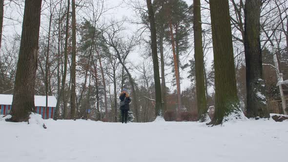 Woman With Phone Walking In The Park