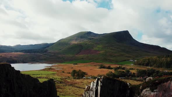 Aerial descent from the autumn landscape of Snowdonia into the black walls of the slate quarry.Snowd