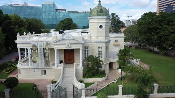 Aerial pull back over Paseo de Montejo showing the Casa Museo Quinta Montes Molina in Merida, Yucata