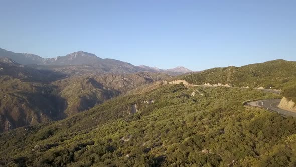 Drone Flying above road with mountains