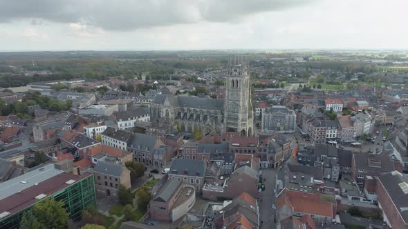 Cityscape of Tongeren and Basilica of Our Lady, Belgium. Aerial flying backwards
