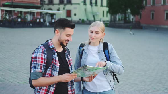 Tourists Holding Map and Looking for Some Place on City Square