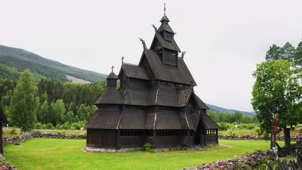 Establishing drone shot of the Heddal Stave Church in Norway. Wide shot, push in.