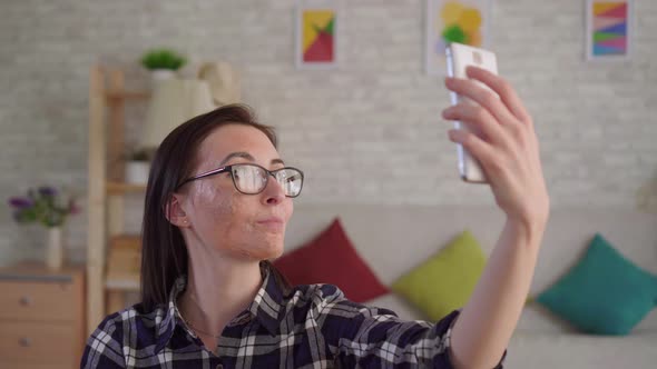 Close Up Young Woman with a Scar From a Burn on Her Face Takes a Selfie