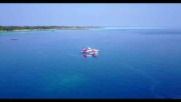 Aerial drone shot sky of idyllic coast beach vacation by blue sea and white sandy background of a da