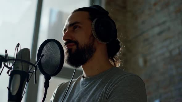 A Male Singer Records a Song at a Recording Studio