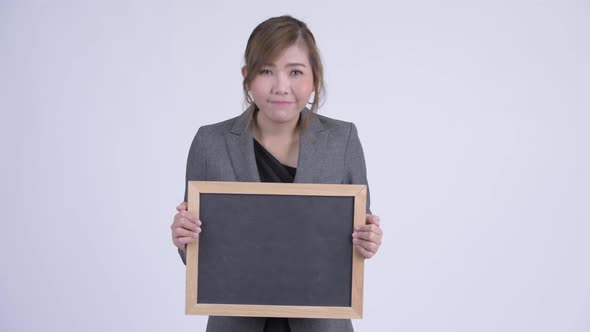 Young Happy Asian Businesswoman Holding Blackboard