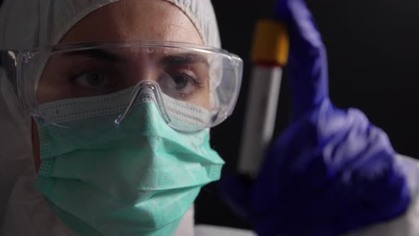 Doctor Holding Beaker with Virus Blood Test