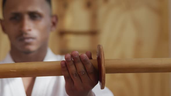 Close up view judoka holding a wooden saber