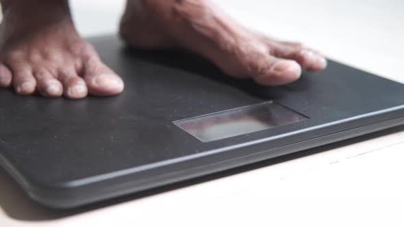 Senior Women Feet on Weight Scale Close Up