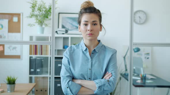 Slow Motion Portrait of Beautiful Asian Woman Office Worker Standing Indoors with Arms Crossed