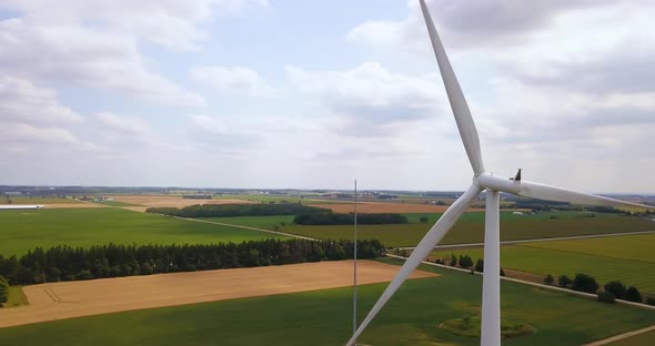 Aerial flying around the spinning blades of a wind turbine