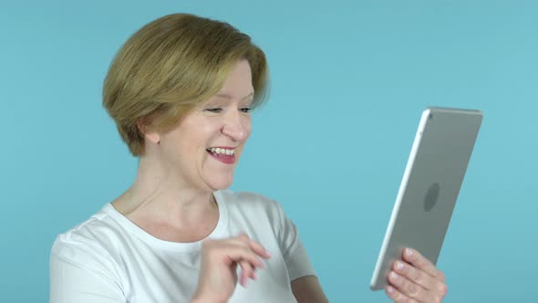 Video Chat By Old Woman Via Tablet Isolated on Blue Background
