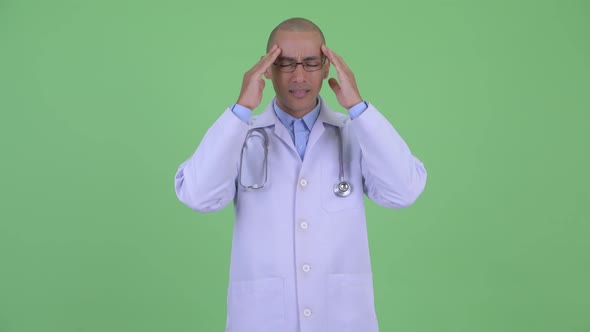 Stressed Bald Multi Ethnic Man Doctor Having Headache
