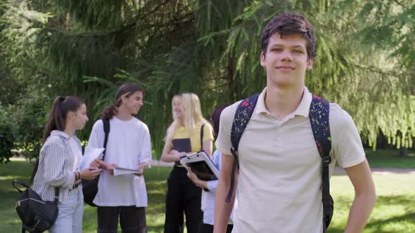 Male Student 16 17 Years Old with Backpack in School Park