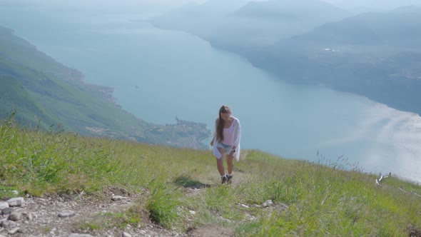 Young Girl Climbs the Mountain in the Alps