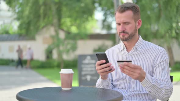 Middle Aged Man with Unsuccessful Online Payment on Smartphone