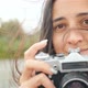 A Beautiful Girl Holds a Camera and Takes Pictures - VideoHive Item for Sale