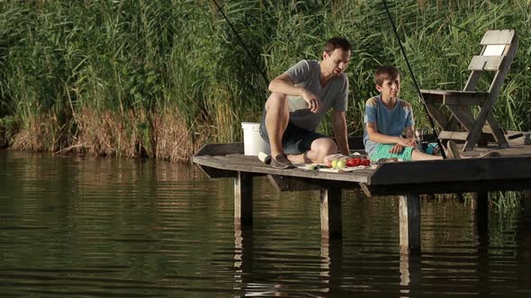 Fishermen Having Breakfast on Wooden Pier at Pond