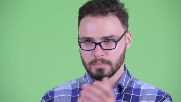 Face of Serious Young Bearded Hipster Man Clapping Hands