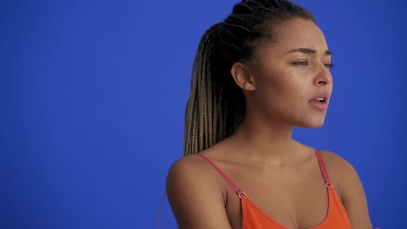 African woman with braid hairstyle showing silence gesture