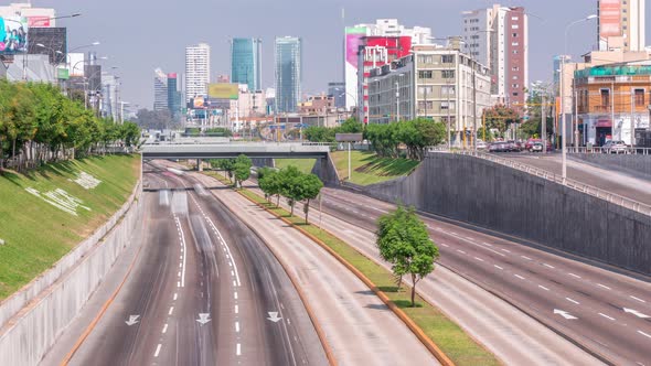 Aerial View of Via Expresa Highway and Metropolitan Bus with Traffic Timelapse and Blue Sky with