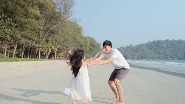 Asian Family playing together at beach with kids happy vacation travel beach concept