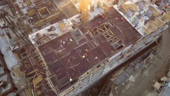 Aerial top view of construction worker work on building at construction site